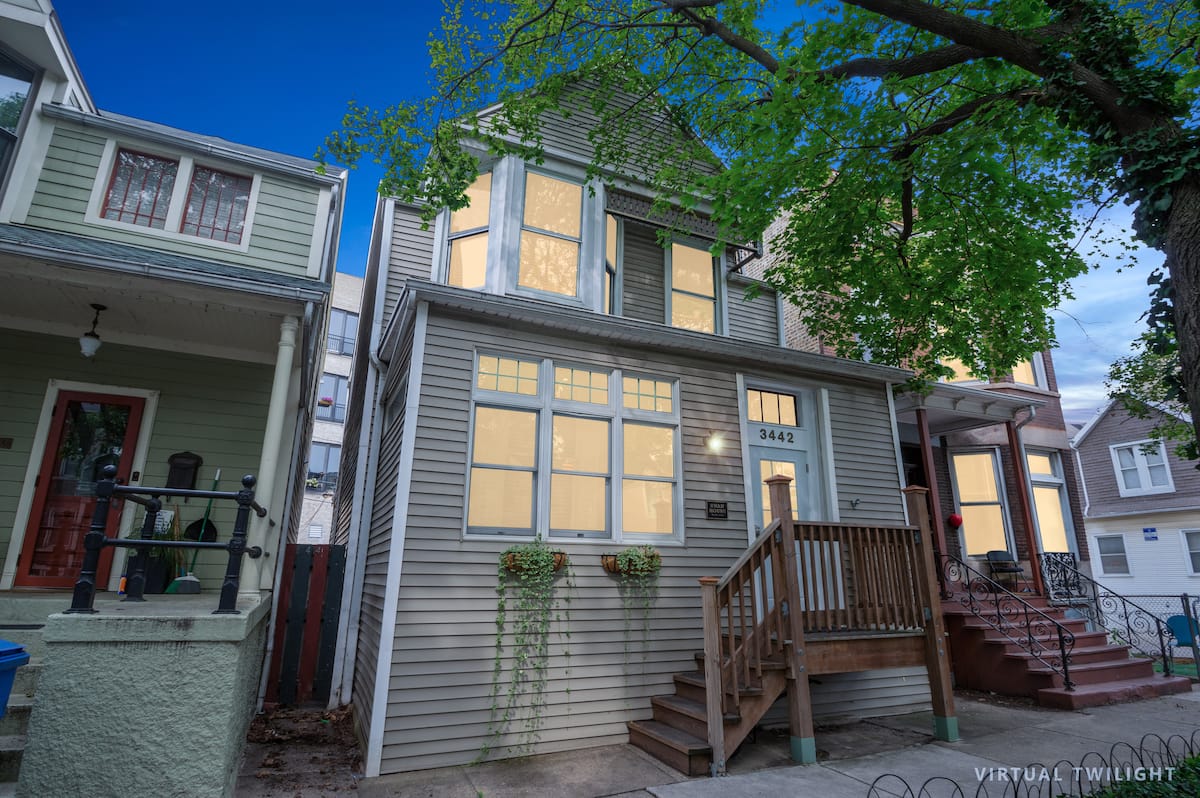 The front of Swan House, an 1895 house on a tree-lined Roscoe Village street